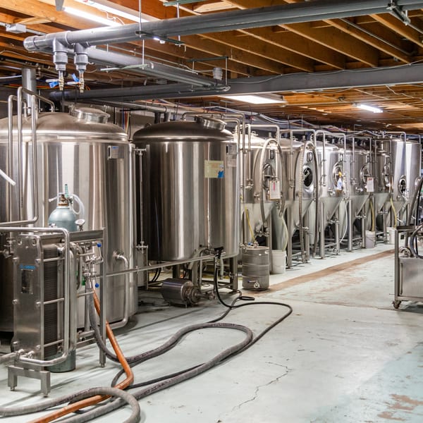 Stainless steel brewing tanks and equipment line the floor of The 377 Brewery.