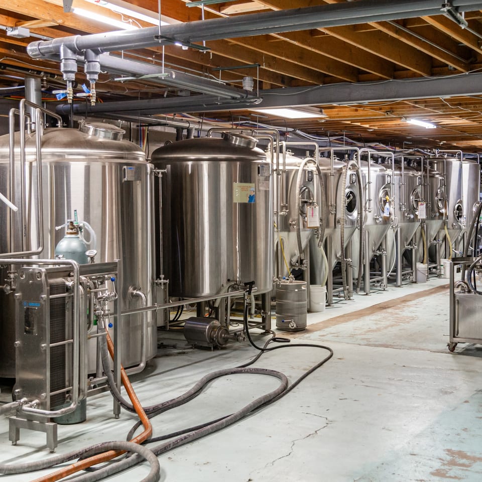 Stainless steel brewing tanks and equipment line the floor of The 377 Brewery.