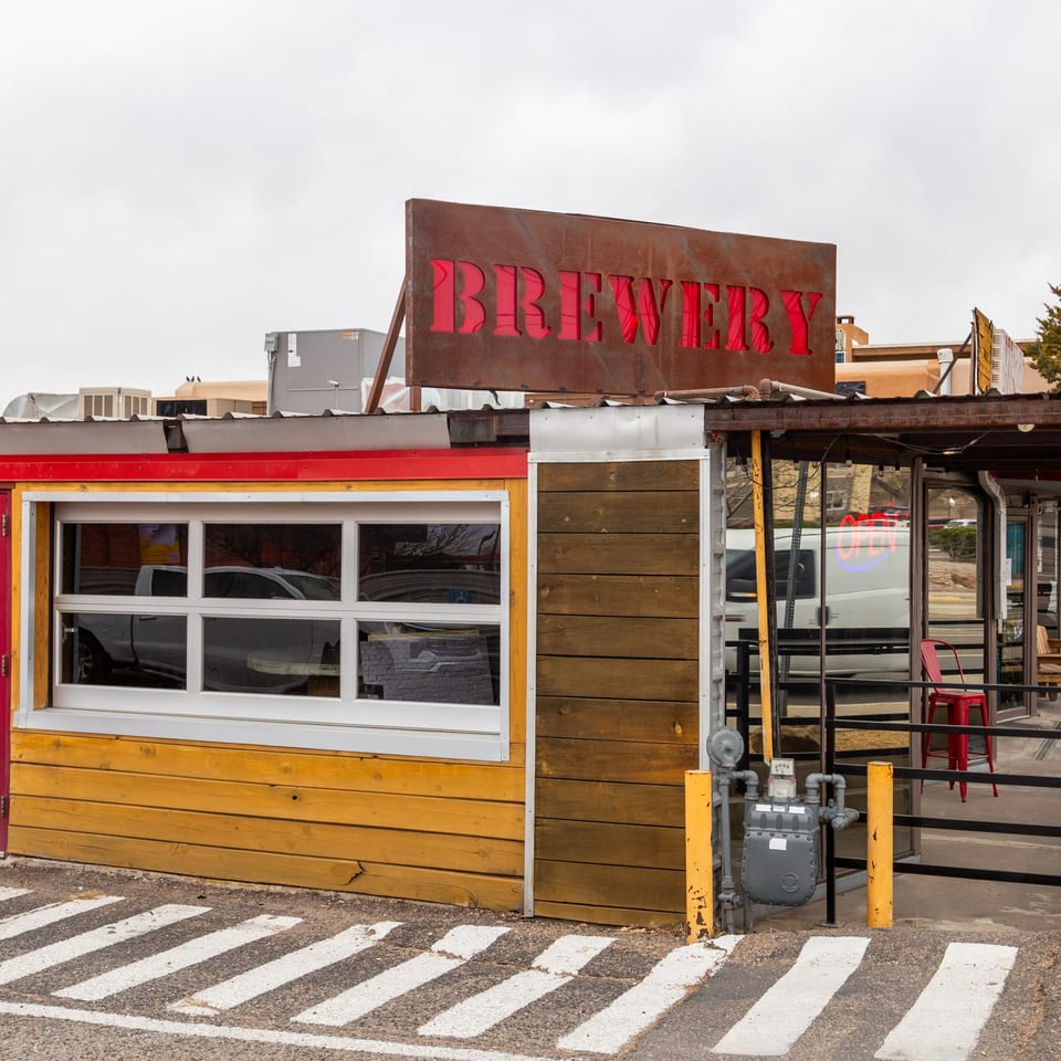The 377 Brewery's rustic exterior with a red "BREWERY" sign and a yellow-paneled wall.